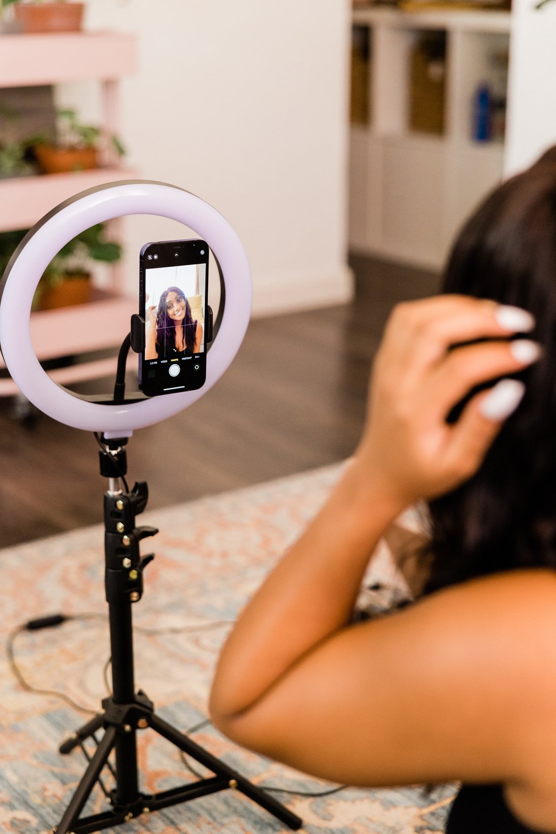 Woman Recording Herself on Smartphone with Ring Light